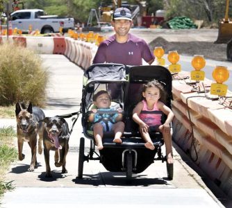 Family out for a stroll with dogs in tow